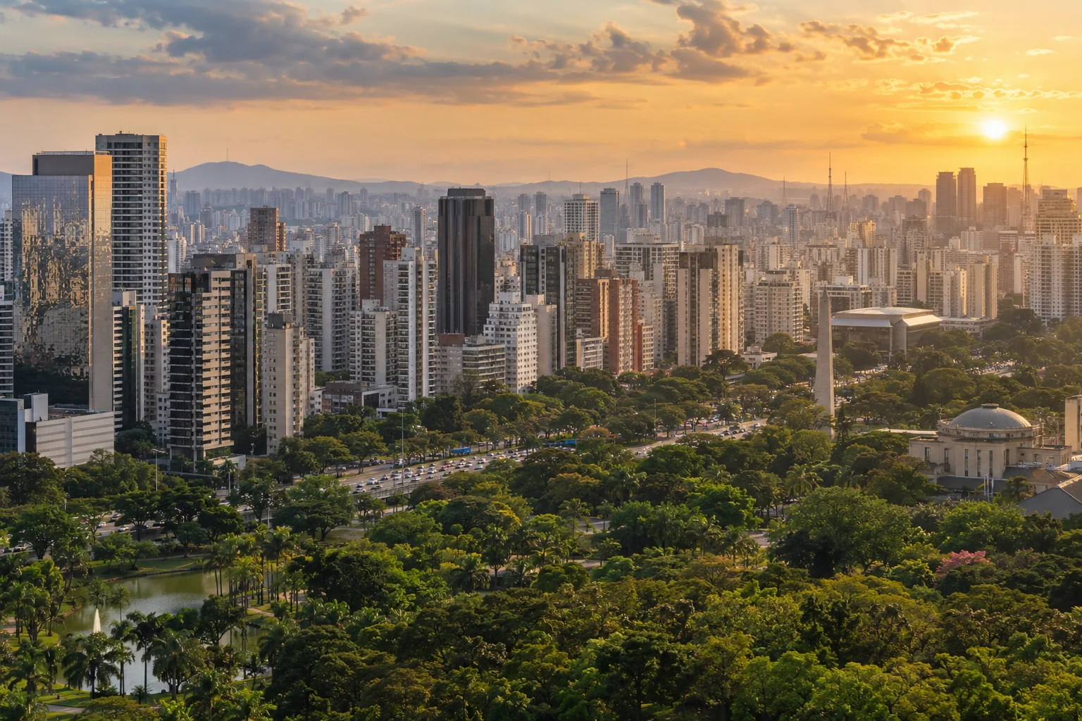 A sweeping elevated panorama of dense modern towers above a green foreground park and urban avenues, believable varied architecture in warm late-afternoon haze