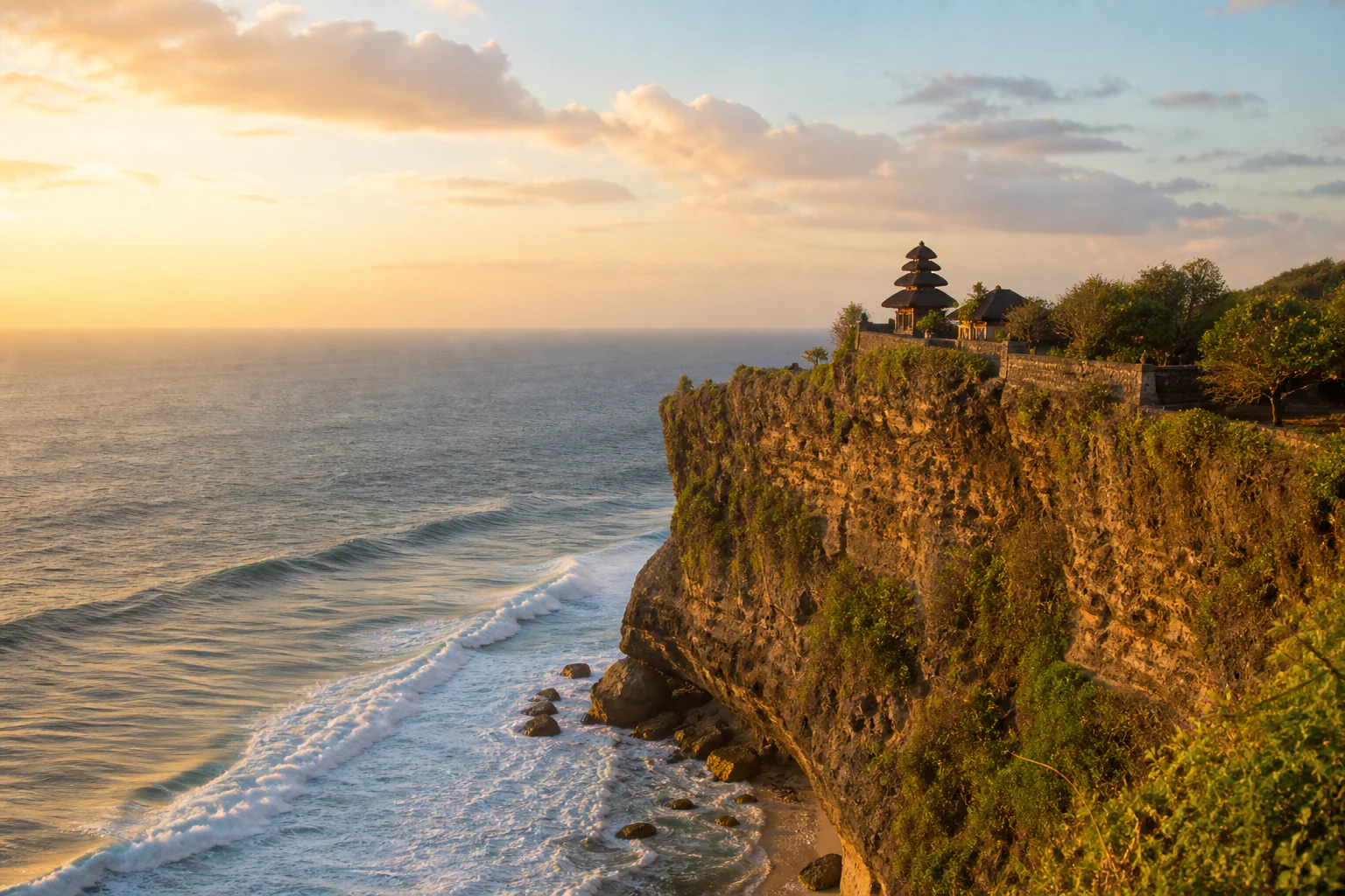 Uluwatu's limestone cliffs and turquoise surf at sunset