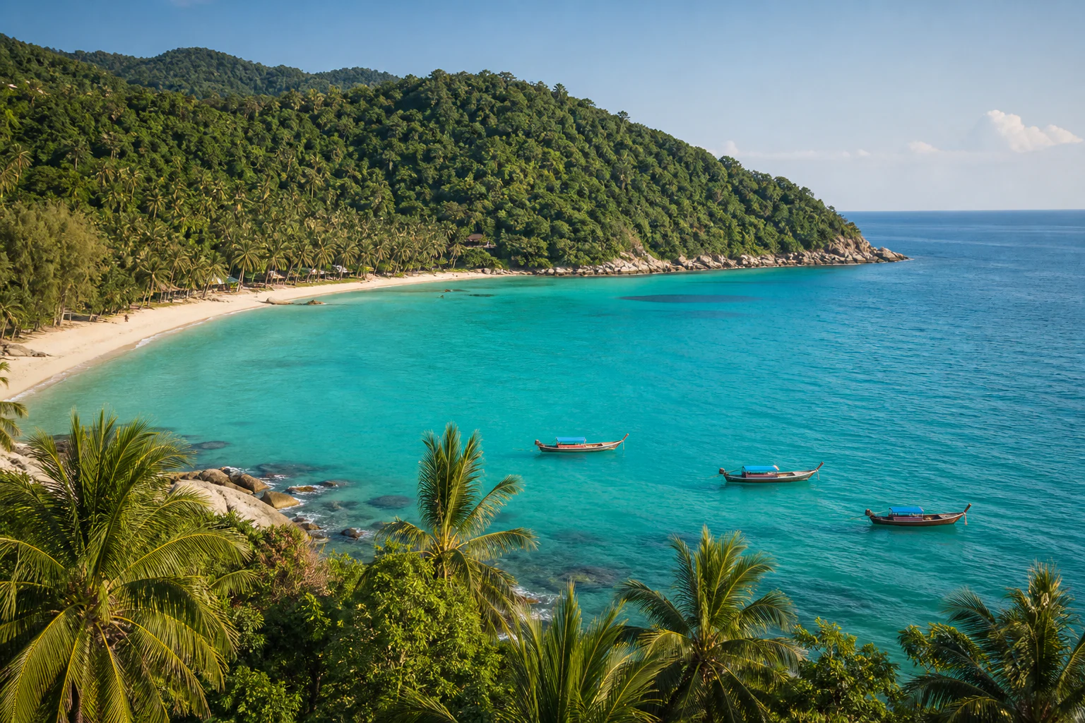 A quiet turquoise bay and forested hills on Koh Phangan
