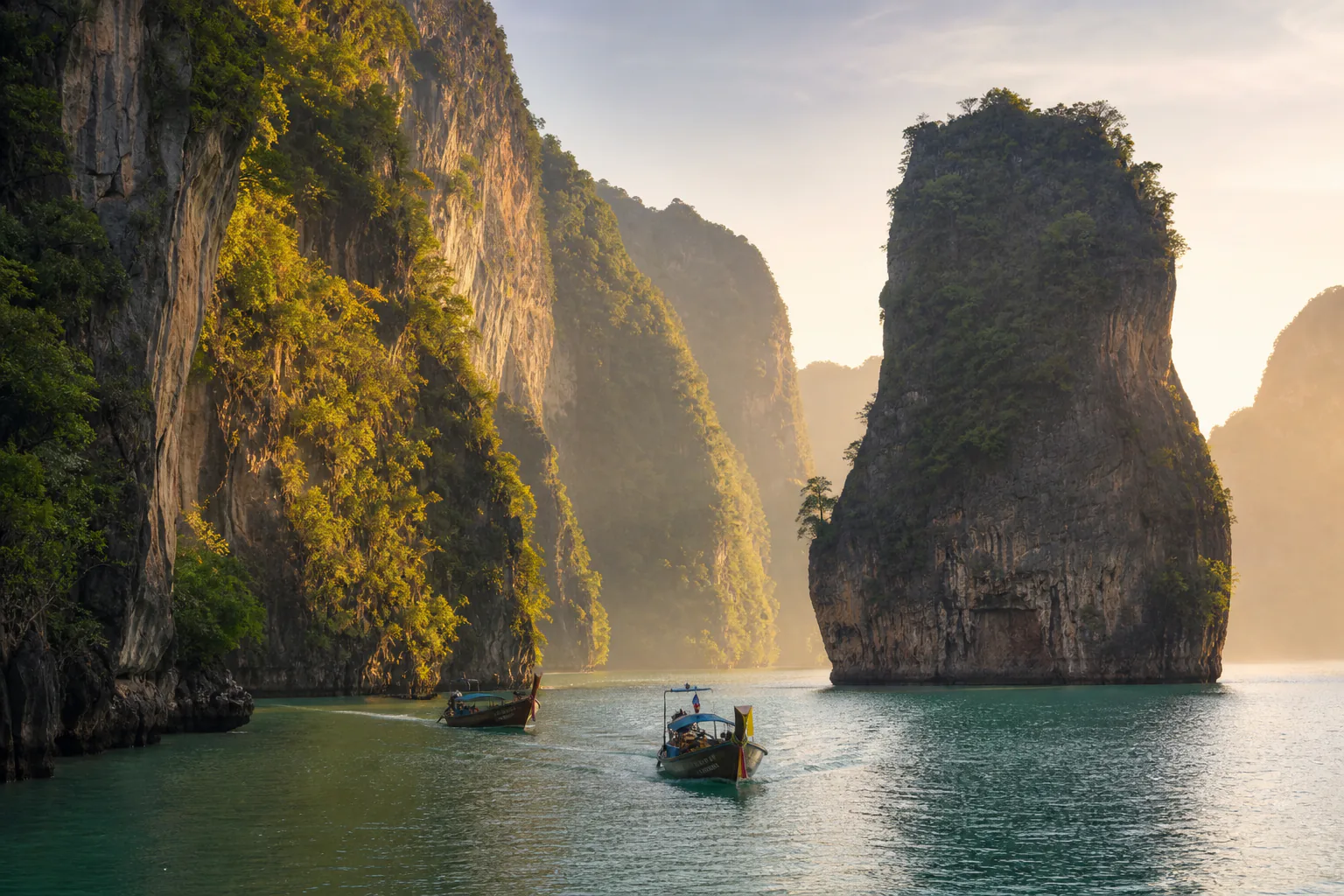 Longtail boats on a limestone bay in southern Thailand