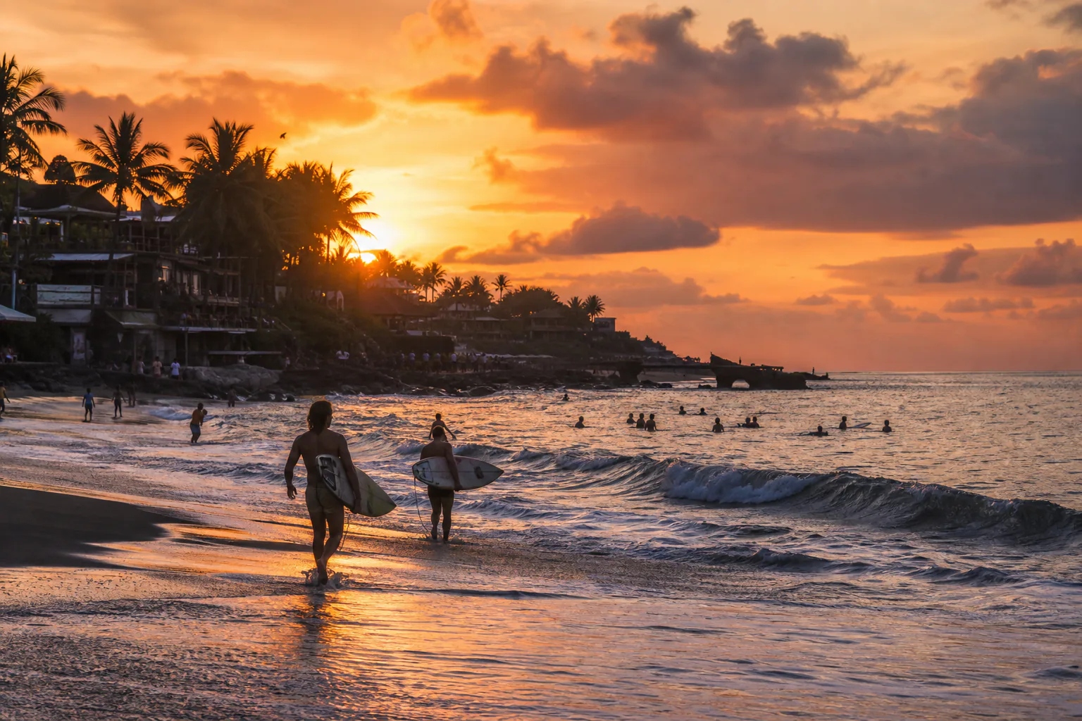 Surfers at Batu Bolong beach at sunset