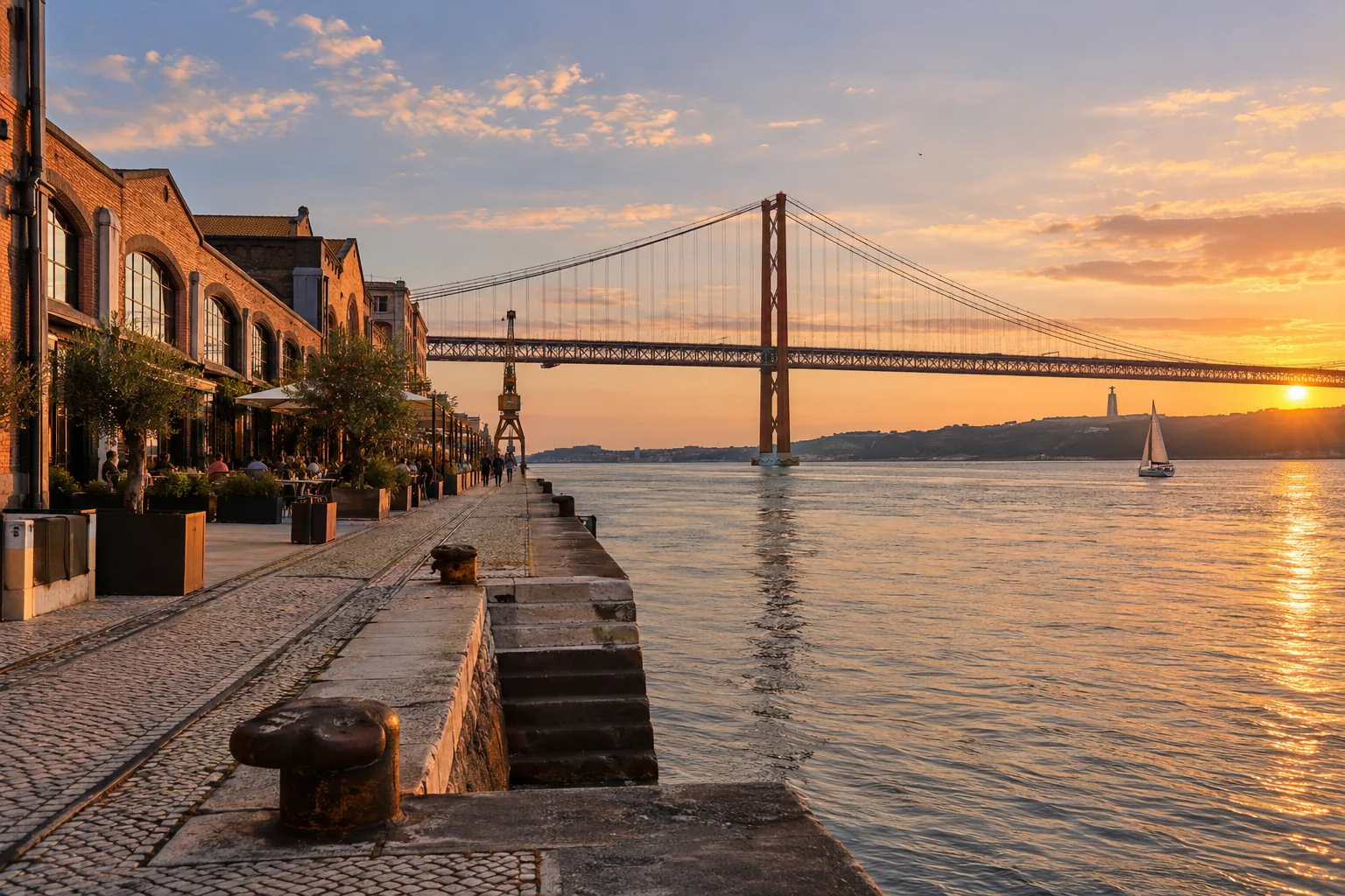 The riverside docks below the 25 de Abril suspension bridge, converted brick warehouses and a calm Tagus waterfront