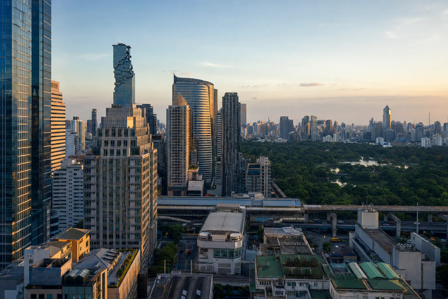 Office towers above Sathorn road with Lumphini Park beyond